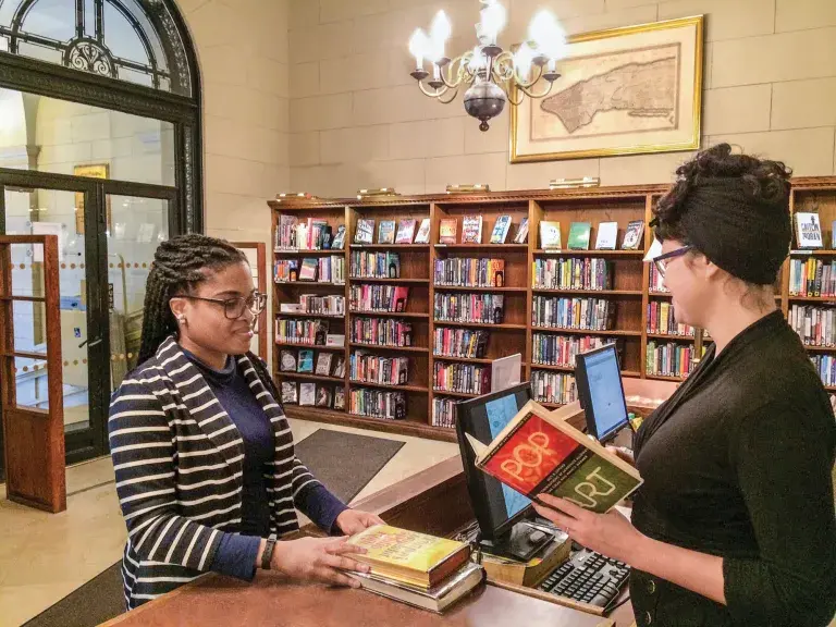 new york society library member checking out a book
